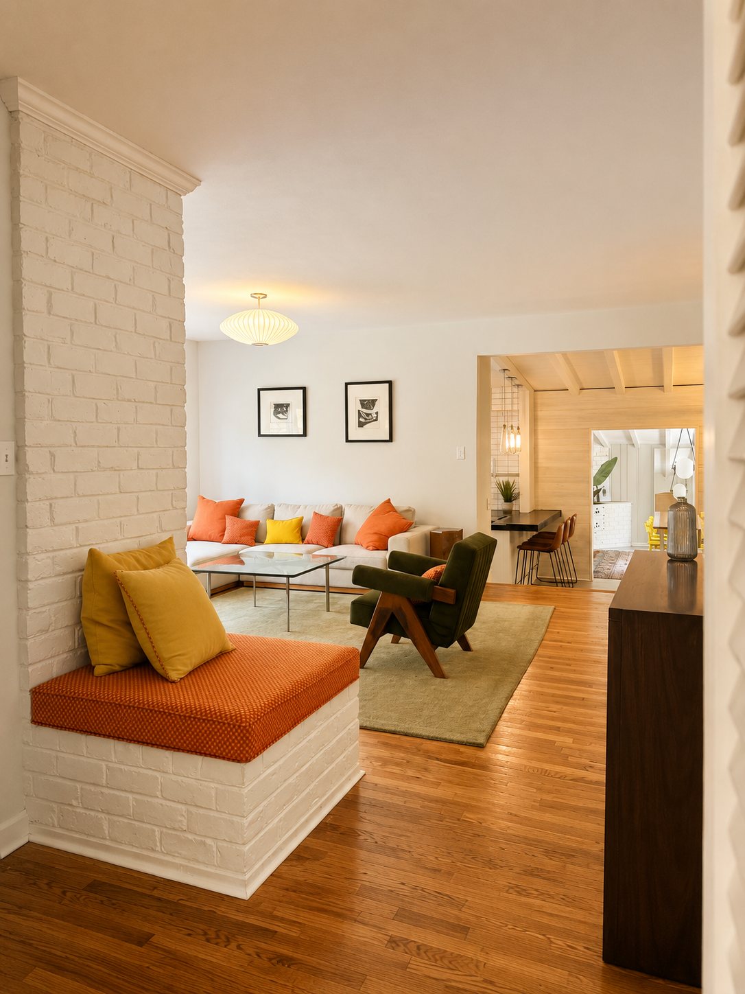 Living room with painted brick fireplace bench and view through to the dining room