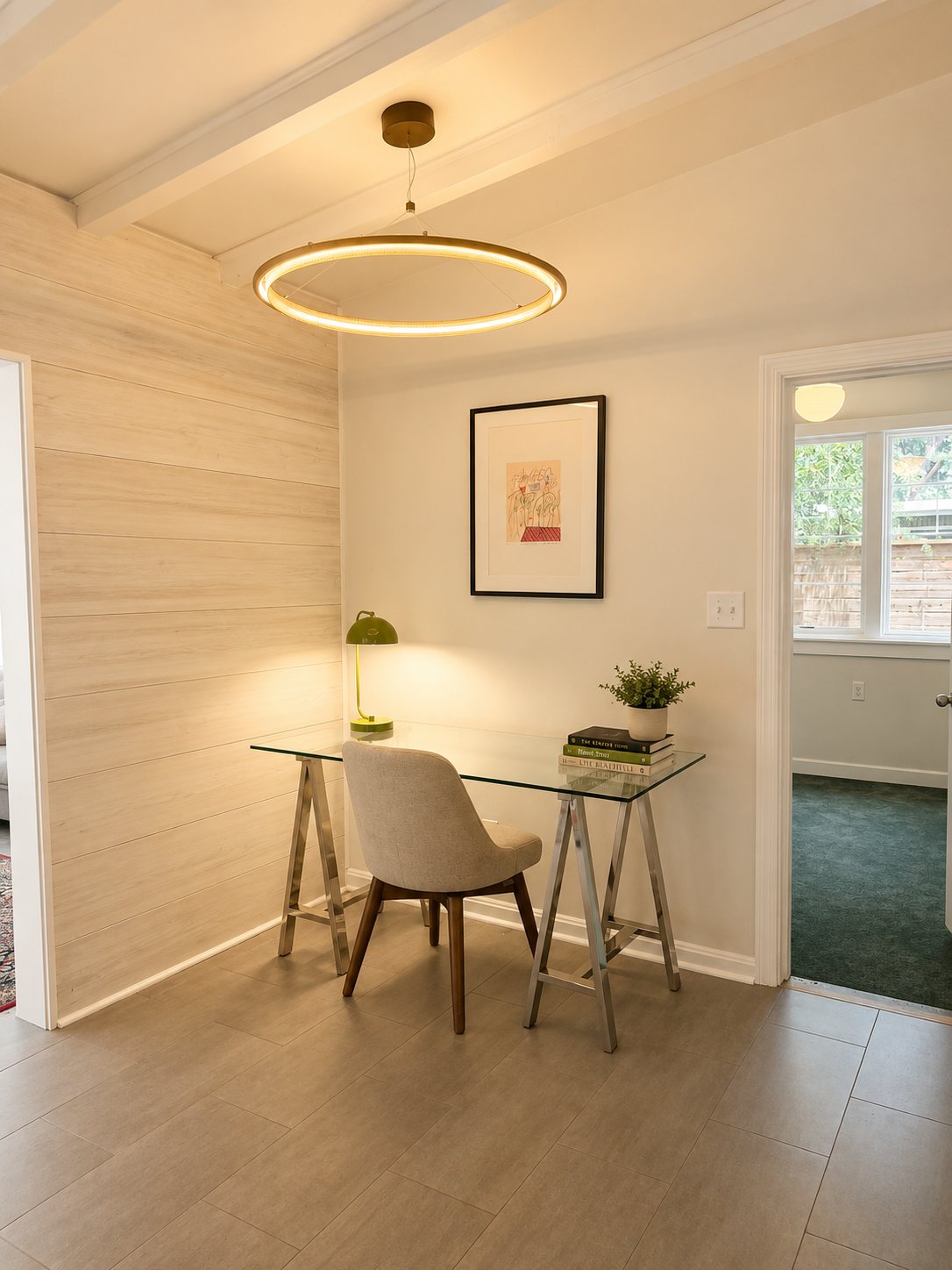 Office nook with desk beneath a halo pendant light